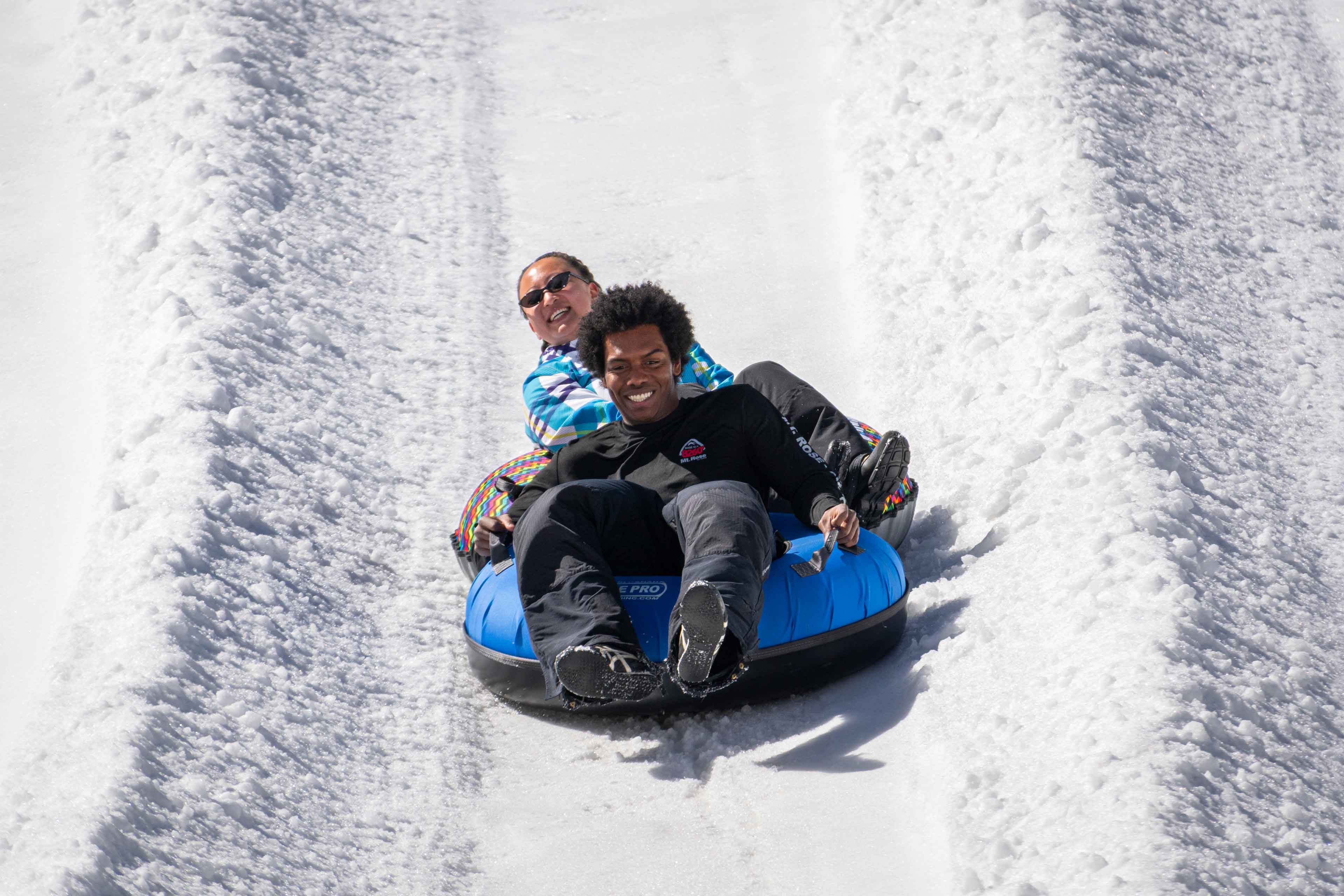 couple sliding on a tube at wildslide tahoe winter park