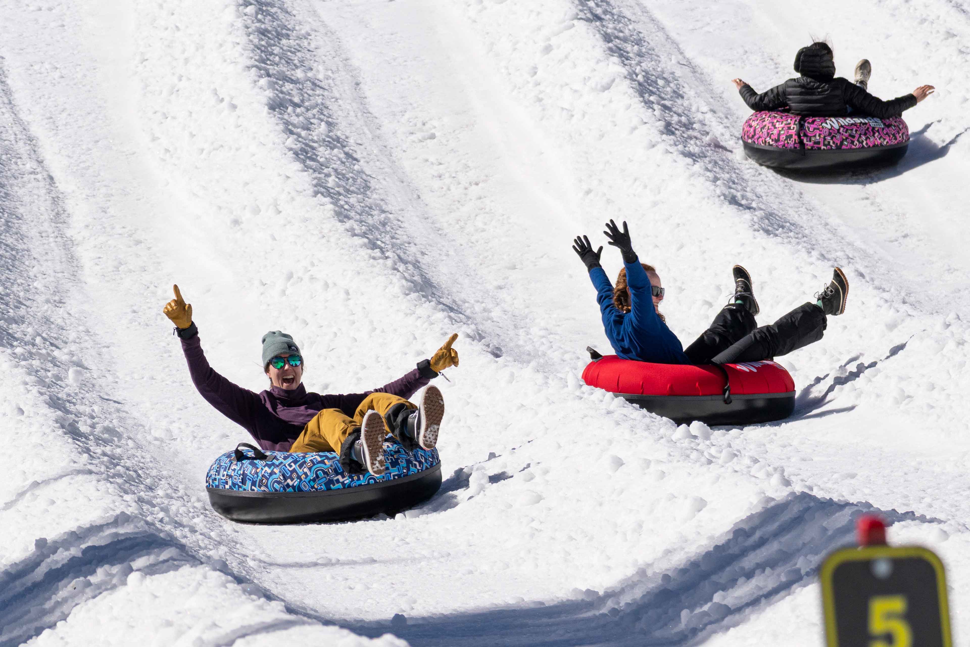 friends having fun sliding down in tubes at wildslide tahoe