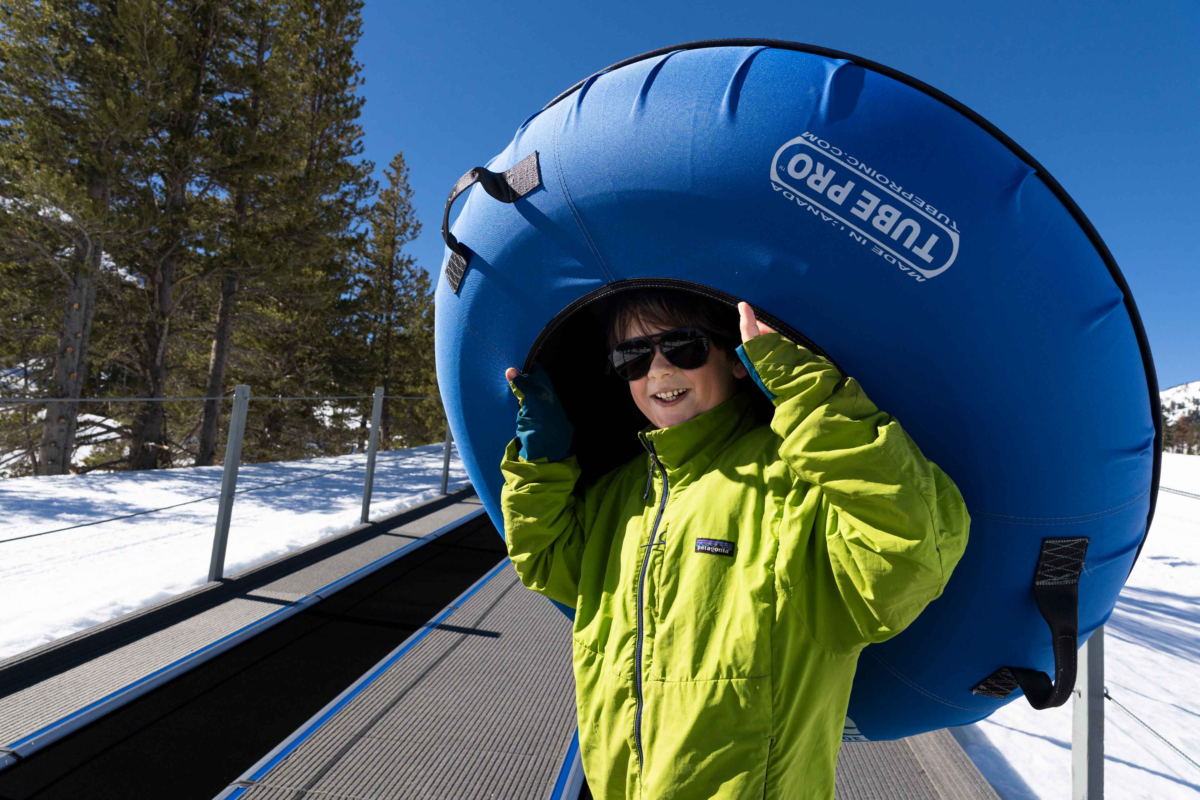kid carrying a tube to slide down at wildslide winter park