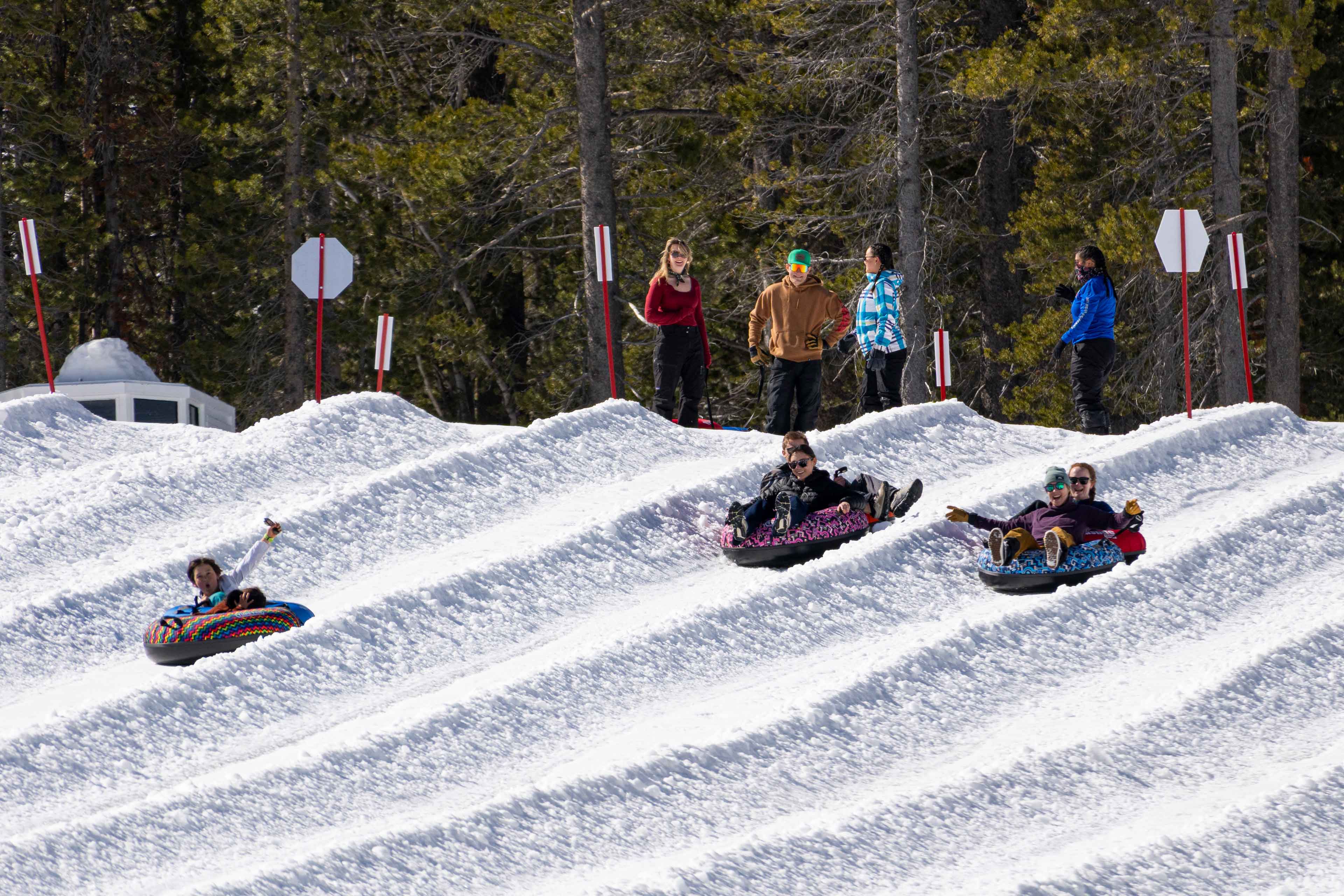 people sliding down in tubes at wildslide winter park