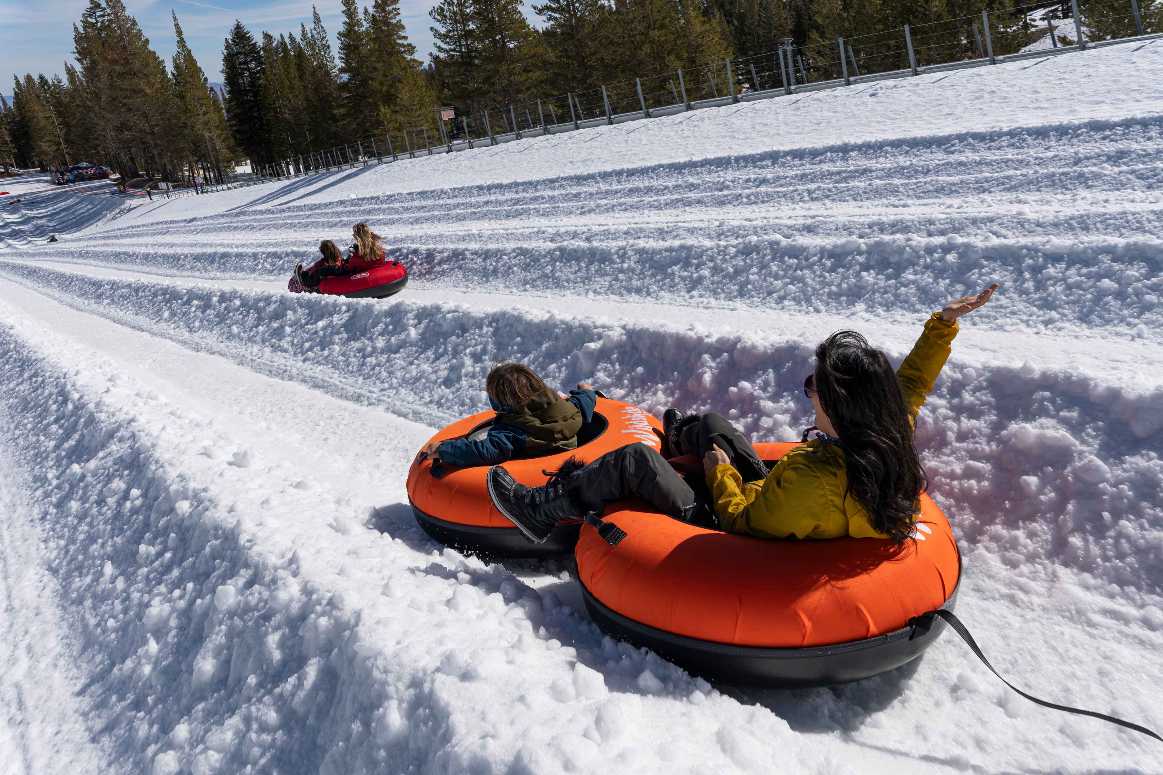 snow lanes at wildslide tahoe full of people sliding in tubes